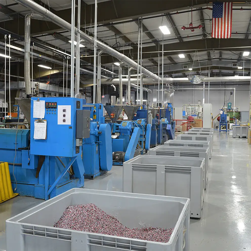 overview-interior-of-frl-warehouse-with-large-bins-of-plastic-materials-and-pellets-and-machinery.webp