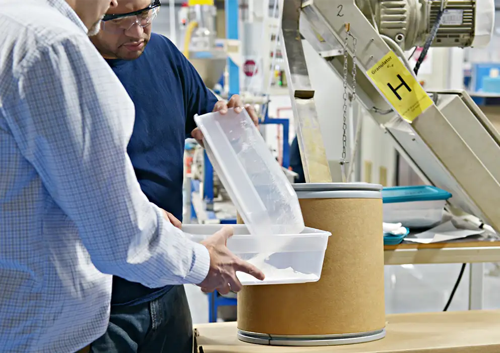 frl-team-transferring-plastic-pellets-and-materials-into-large-clear-bin.webp