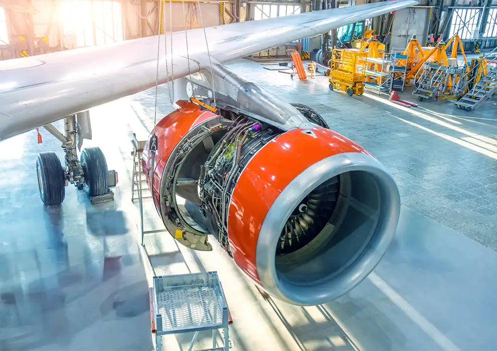 close-up-of-open-engine-cowling-of-airplane-in-hangar.webp